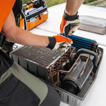Technician servicing RV air conditioning unit